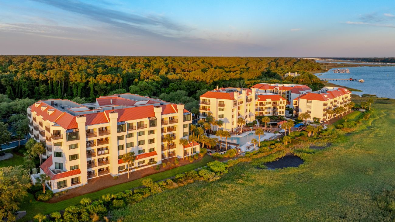 Exterior and grounds of Marriott's Sunset Pointe resort timeshare with pond fountain in foreground